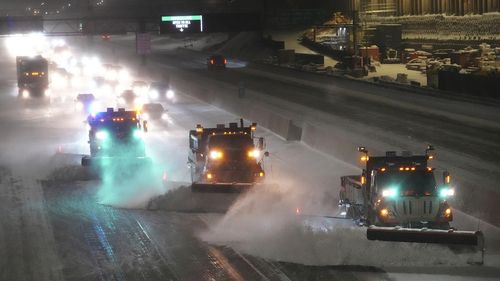 Plows move snow from I-35W southbound seen from the 42nd St. Bridge on Wednesday in Minneapolis.