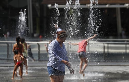 A woman refreshes at a fountain in Milan, Italy. Hot air from Africa is bringing a new heatwave to Europe, prompting health warnings (File image)