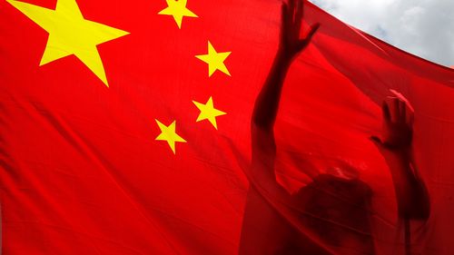 A pro-China supporter holds a Chinese national flag during a rally to celebrate the approval of a national security law for Hong Kong, in Hong Kong