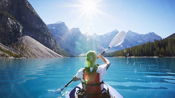 Kayaking the glacial waters of Moraine Lake, Banff National Park, Canada.