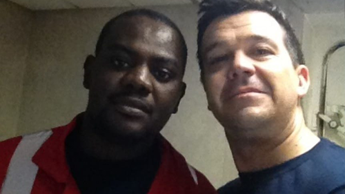 Alex Gibbs and Harrison Okene pose for a photo shortly after the 29-year-old's rescue. 