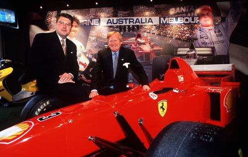 Mr Walker with a Ferrari during the 1999 announcement that Melbourne would host the 2000 Formula One Grand Prix. (Getty)