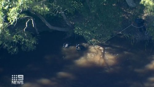 Divers search the dam for any remaining evidence, despite it being after the mum's murder.