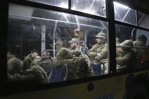 Ukrainian servicemen sit in a bus after leaving Mariupol's besieged Azovstal steel plant, near a penal colony, in Olyonivka, in territory under the government of the Donetsk People's Republic, eastern Ukraine, Friday, May 20, 2022. (AP Photo)