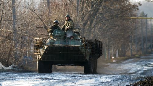 Ukrainian servicemen ride an Armoured Personnel Vehicle (APC) in the village of Horlivka near Donetsk. (Getty Images)