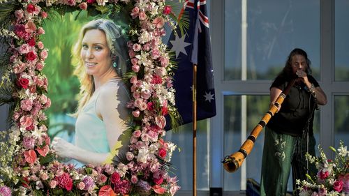 n this Aug. 11, 2017, file photo, Johanna Morrow plays the didgeridoo during a memorial service for Justine Ruszczyk Damond at Lake Harriet in Minneapolis.