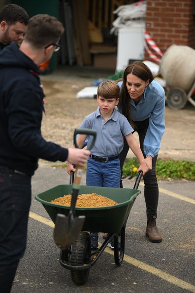Prince Louis of Wales uses a wheelbarrow as he helps his mother, Catherine, Princess of Wales, take part in the Big Help Out, during a visit to the 3rd Upton Scouts Hut in Slough on May 8, 2023