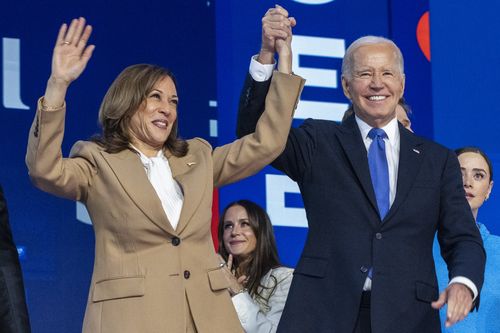 Democratic presidential nominee Vice President Kamala Harris, left, clasps her hand in the air with President Joe Biden at the Democratic National Convention, Monday, Aug. 19, 2024, in Chicago. (AP Photo/Jacquelyn Martin)