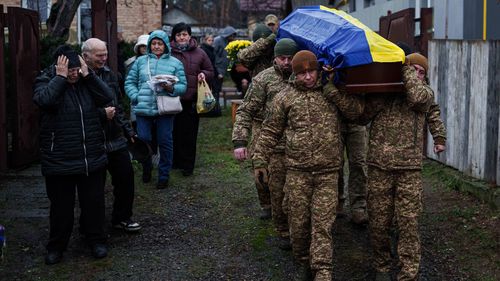 An honor guard carries the coffin of Ruslan Zhygunov, a Ukrainian serviceman, who was killed at the frontline near Rusyn Yar village, during his funeral ceremony in Hostomel, Ukraine. Ukraine's allies pushed back against Donald Trump's proposed peace plan, saying it favoured Russia.