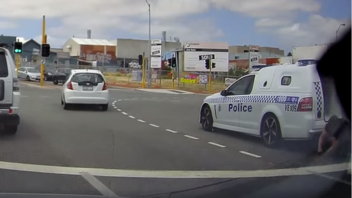 Man captured on dash cam falling out of a police van in Perth.