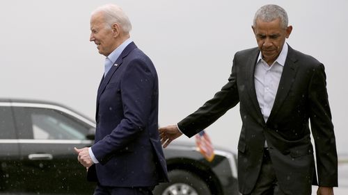 President Joe Biden, left, and former President Barack Obama arrive at John F. Kennedy International Airport