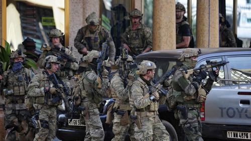 French special forces take up positions outside the Splendid Hotel in Ouagadougou. (AAP)