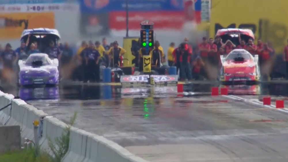 Drag car speeds down raceway while bursting into flames at NHRA New England Nationals