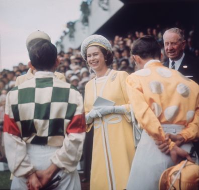 Queen Elizabeth II chats with jockeys Ron Quinton and Hilton Cope before the Queen Elizabeth Stakes at Randwick race course near Sydney, during her tour of Australia, 1st April 1970. (Photo by Keystone/Hulton Archive/Getty Images)