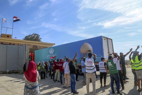 A truck of the Egyptian National Alliance carrying humanitarian aid for the Gaza Strip cross the Rafah border gate, in Rafah, Egypt, Saturday, Oct. 21, 2023.  