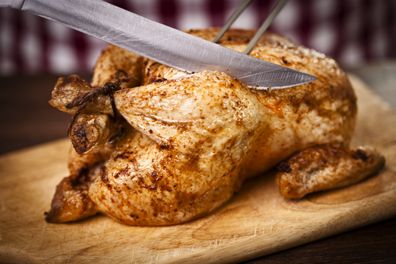 Carving a delicious roast chicken istock