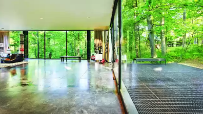 The spacious living and outdoor space of the glass walled Ben Rose House.