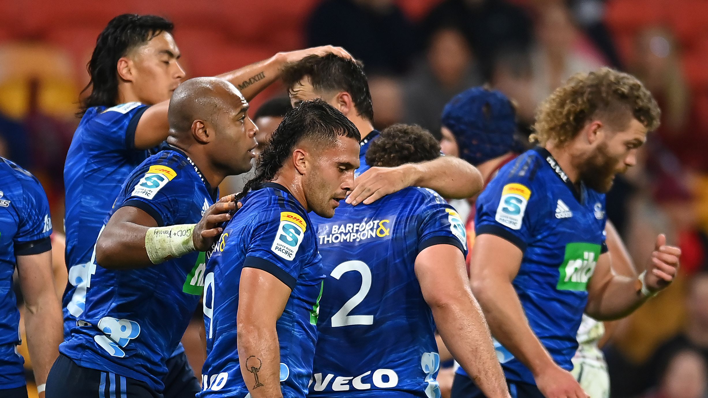 Blues celebrate after scoring a try during the round 13 Super Rugby Pacific match against the Queensland.