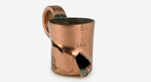 A damaged 'rum ration' cup from the HMS Vindictive, a Royal Navy warship. Eleven Australian volunteers on board the Vindictive were part of a dangerous raid to blockade the German-held port of Zeebrugge in April 1918. (IWM) 