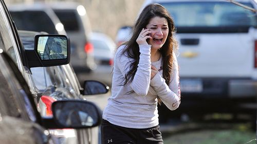 A woman waits to hear about her sister, who is a teacher at Sandy Hook. (AAP)