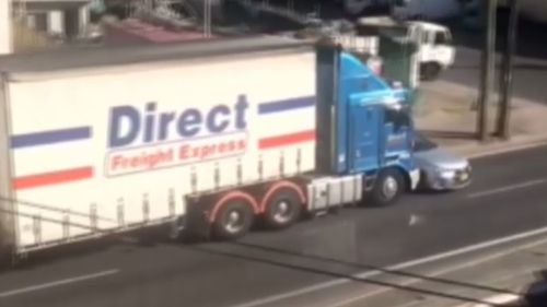 A Direct Freight Express B-Double truck has been filmed ramming a car down the Princes Highway in Sydenham yesterday (Supplied).