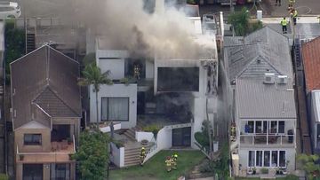 Firefighters have rushed to a multi-million dollar house in Sydney after it caught fire on Boxing Day.Flames were seen coming from the three-level home on Kent Street in Waverley﻿, near Bondi.