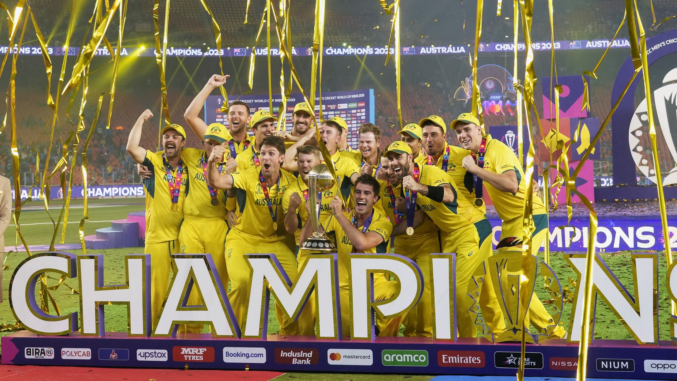 Australia players celebrate with the trophy after Australia won the ICC Men&#x27;s Cricket World Cup final match against India in Ahmedabad, India, Sunday, Nov. 19, 2023. (AP Photo/Rafiq Maqbool)