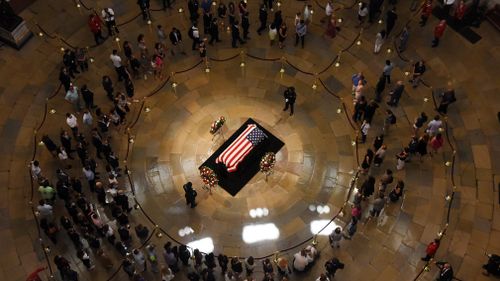 Afterwards thousands of fellow Americans, who had lined up outside the US Capitol in stifling heat, began filing past in the majestic rotunda to say goodbye as McCain lay in state.