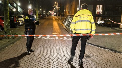 Police near the scene of the shooting at the Grote Wittenburgstraat in Amsterdam. (AAP)