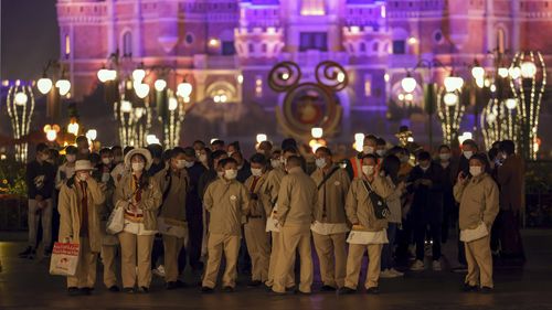 Disneyland employees gather to wait for their COVID-19 tests at the Shanghai Disney Resort in China. 