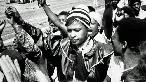 Winnie Mandela is cheered by supporters in 1986 after appearing in the Krugersdorp Magistrate's court, West of Johannesburg in connection with her arrest for flouting a banning order which prevents her from living in her Soweto home. (Photo: AP