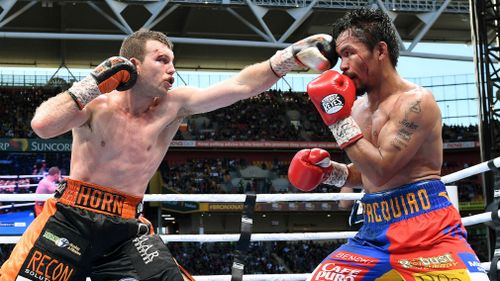 Manny Pacquiao of the Phillipines (right) is struck Jeff Horn of Australia down during the WBO World Welterweight Title fight at Suncorp Stadium in Brisbane on July 2. (AAP)