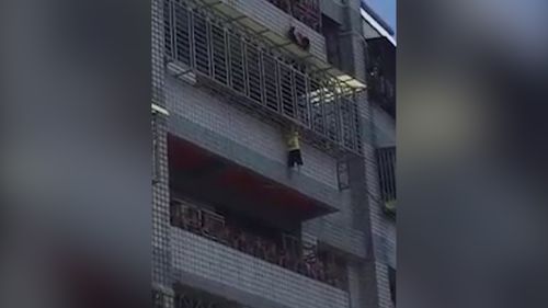 A Taiwanese toddler was seen dangling from a fifth-floor balcony by his head over the weekend in a freak accident. Picture: Taiwan Fun 666 via Storyful.