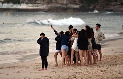 A group poses for a selfie on Bondi.