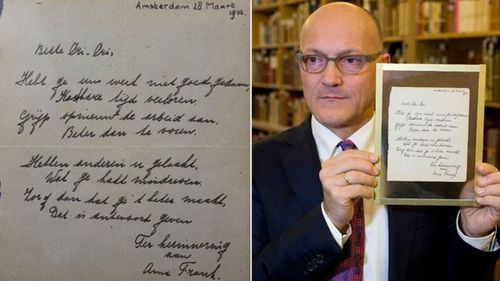 Thijs Blankevoort, director of Bubb Kuyper auction house, holds a short poem by Anne Frank, handwritten and dated in Amsterdam on March 28, 1942. (AAP)