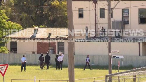 Negotiators are trying to talk the man into coming down from the hotel roof. (9NEWS)