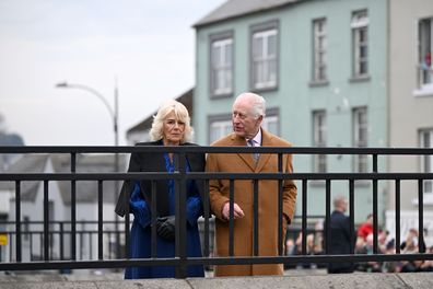 BANBRIDGE, NORTHERN IRELAND - MARCH 21: Queen Camilla and King Charles III walk through Banbridge during an official visit to Northern Ireland on March 21, 2025 in Banbridge, Northern Ireland.  (Photo by Stuart C. Wilson - Pool via Samir Hussein/WireImage)