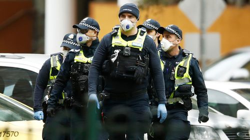 Victoria Police officers patrolling near Melbourne public housing towers.