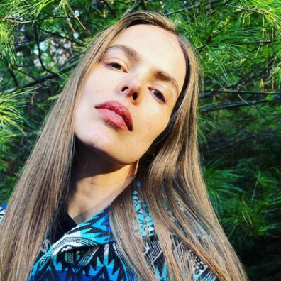 Model, Robyn Lawley, wearing blue patterned print jumper with long, straight, light brown hair out.