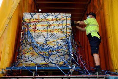 The first Australian shipment of Pfizer COVID-19 vaccines is loaded onto a DHL truck for transport to the storage facility after landing at Sydney International Airport. (AAP Image/Bianca De Marchi)