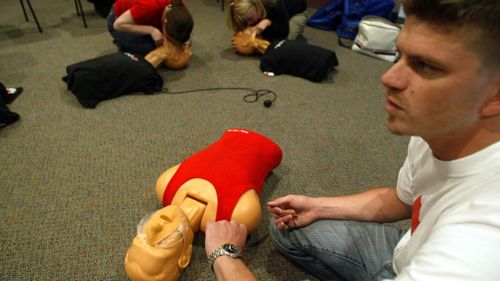 An Australian Red Cross worker demonstrates how to give CPR