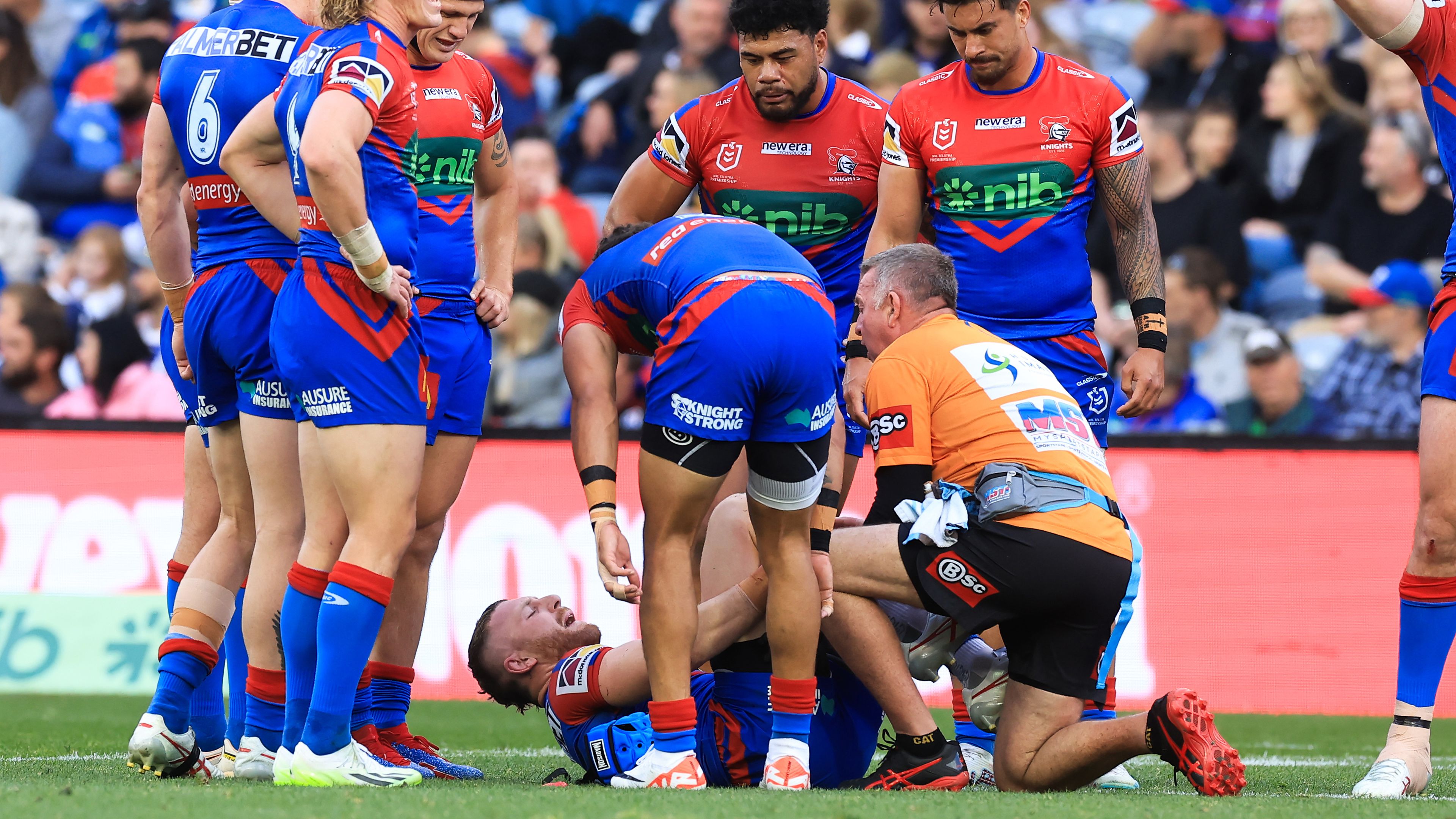 Jackson Hastings of the Knights is injured after a tackle from Jacob Preston.