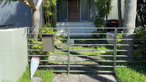 A bunch of flowers left outside Melissa Caddick's home in Dover Heights.