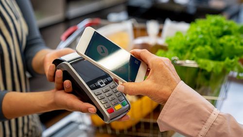 Shopper paying for groceries