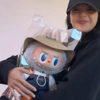 Blackpink's Lisa holding a labubu