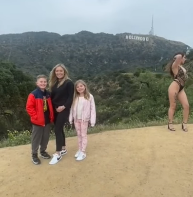 Family photo is ruined by woman posing next to them