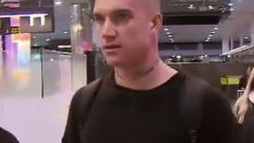 Richmond star Dustin Martin flanked by bodyguards on return from New Zealand