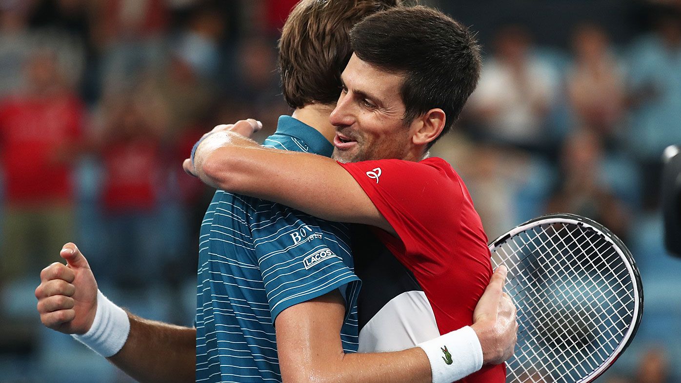  Novak Djokovic of Serbia and Daniil Medvedev of Russia come together after their semi-final