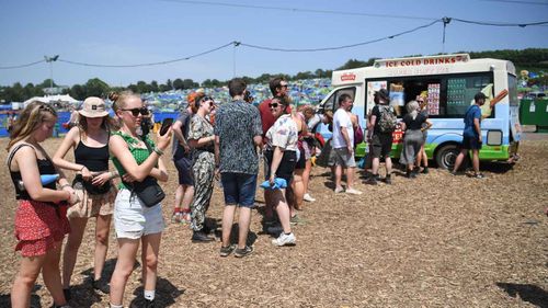 Britons queue up for an ice-cream at the Glastonbury festival.