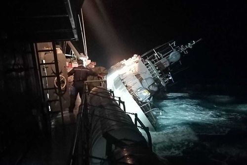 In this photo provided by the Royal Thai Navy, the HTMS Sukhothai corvette warship lists off the coast of Prachuap Khiri Khan province, Thailand.